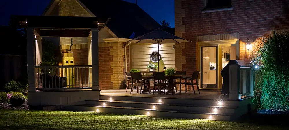 deck with lighting in backyard