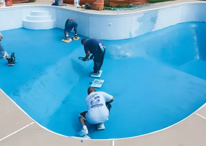 worker resufacing the pool