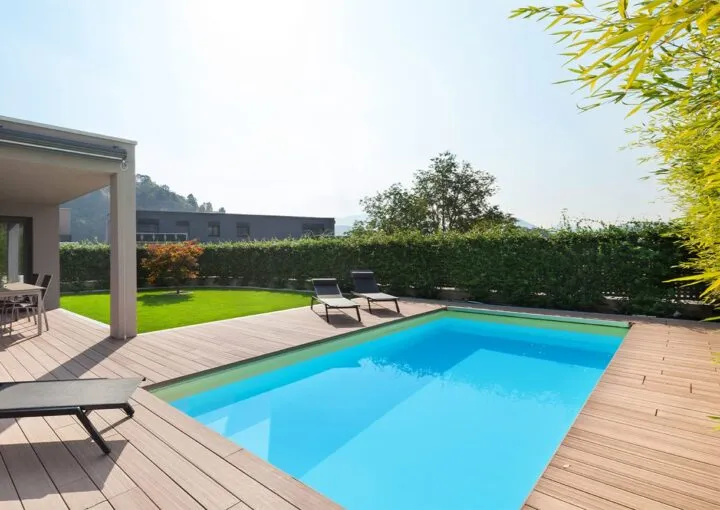 fibreglass pool in backyard with wooden decking