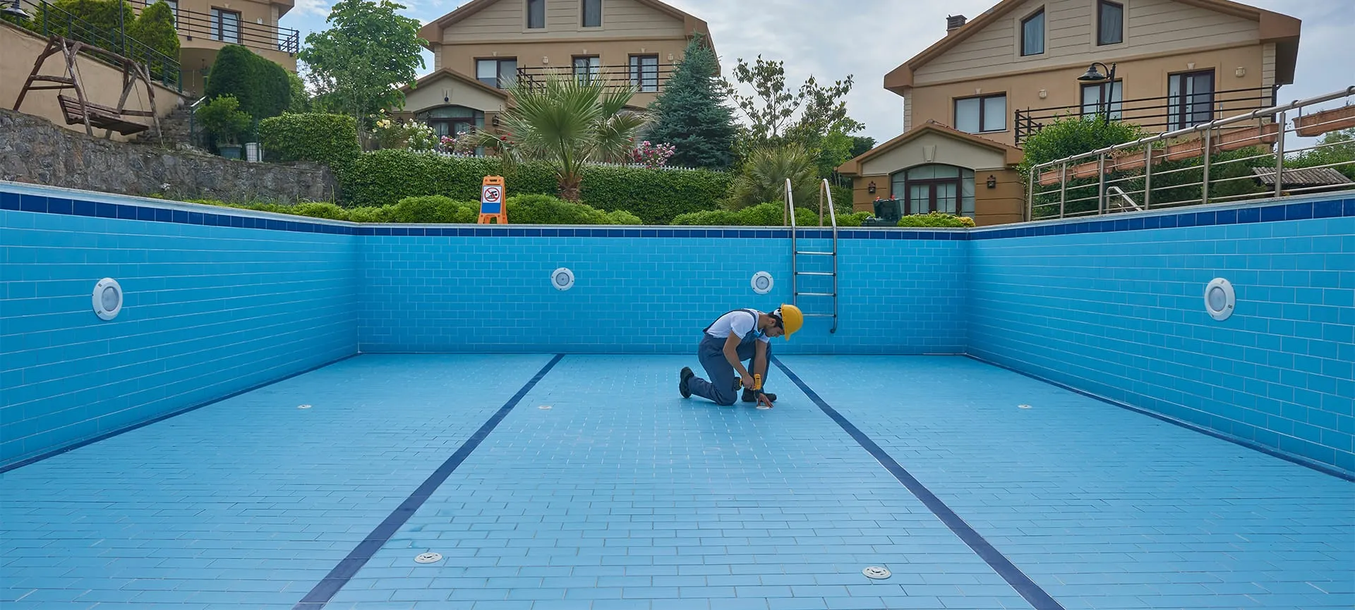 repairman is repairing pool with equipment
