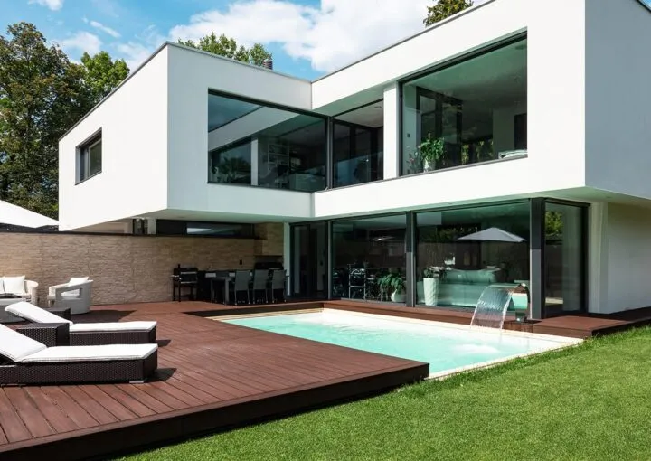 luxury wooden deck around pool in home backyard