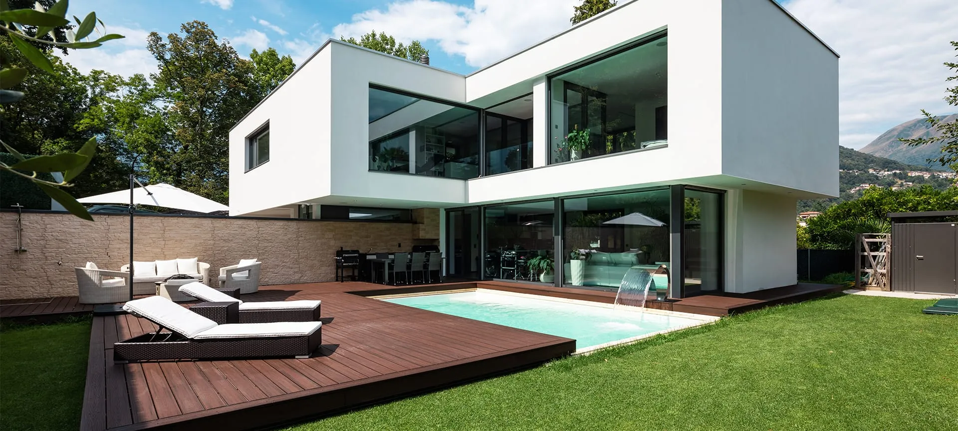 luxury wooden deck around pool in home backyard