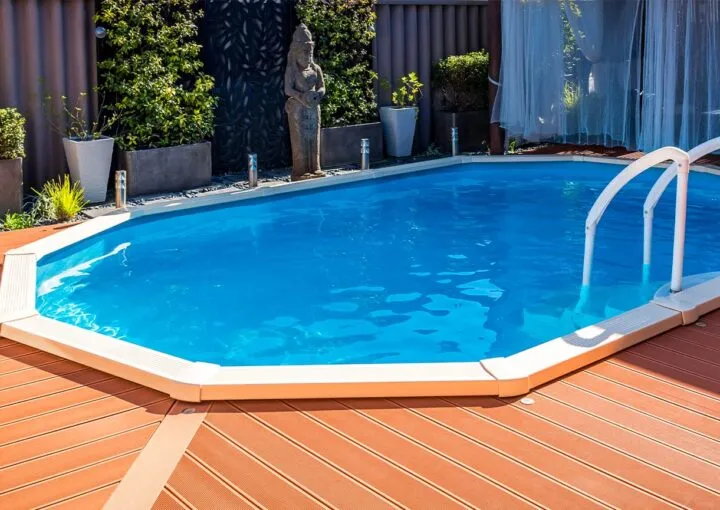 above ground pool sunken below ground and surrounded by decking
