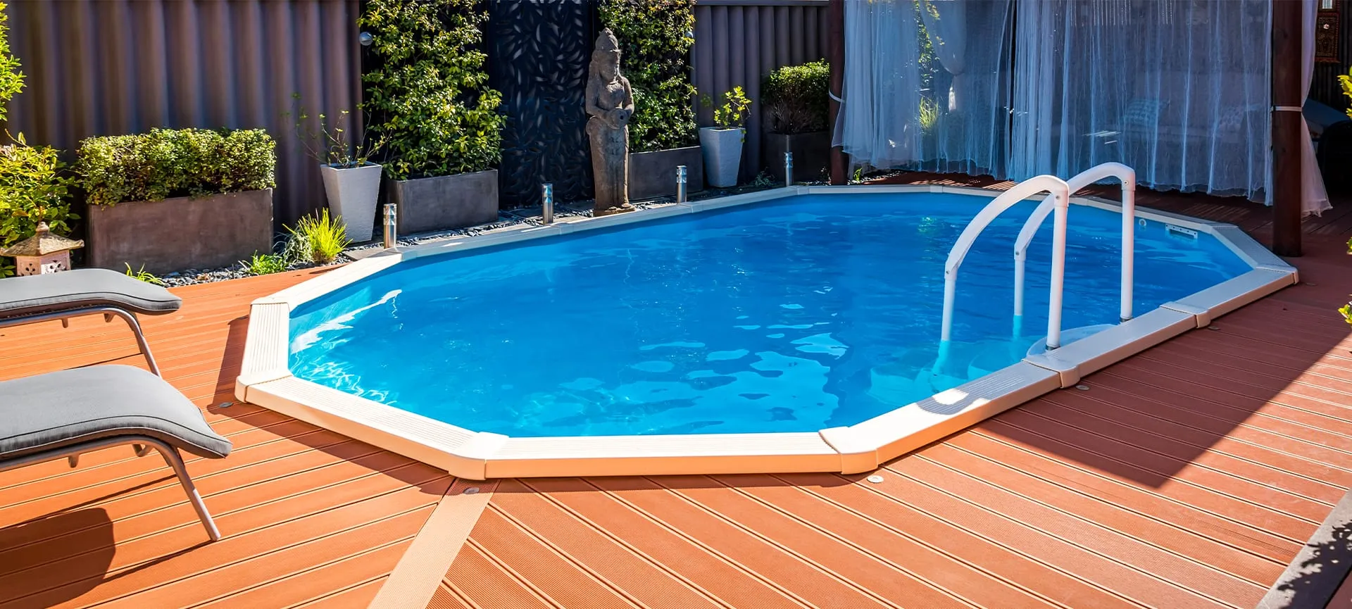 above ground pool sunken below ground and surrounded by decking
