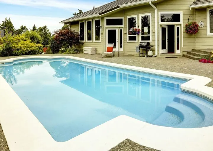 swimming pool with landscaping in the home backyard