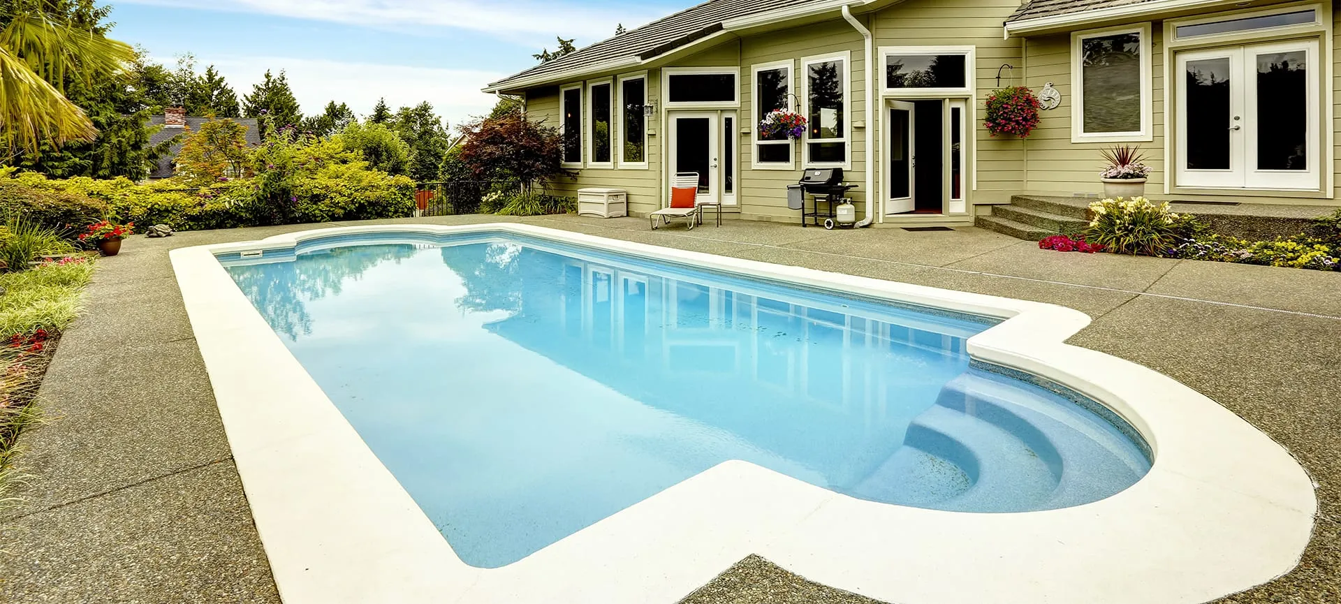 swimming pool with landscaping in the home backyard