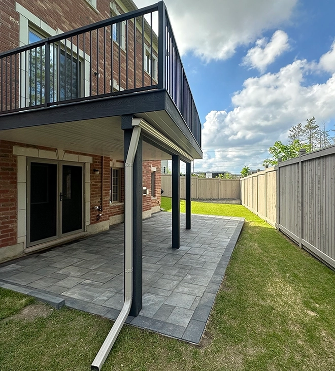 above ground deck with water drainage pipe