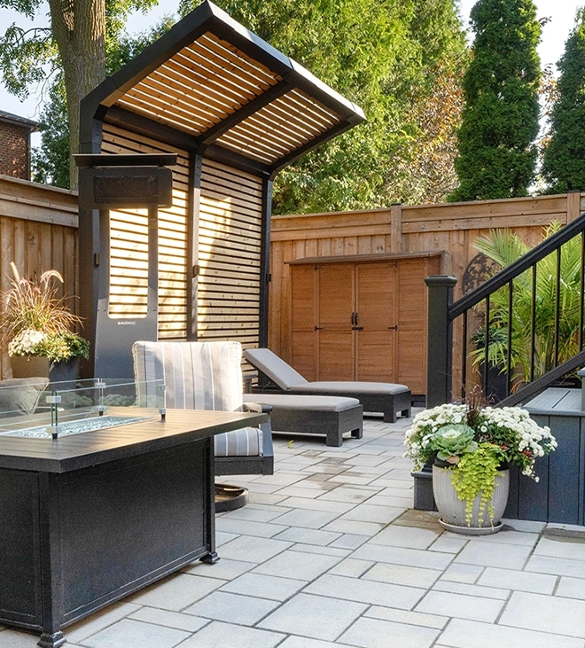 backyard with sitting setup, flowers decor, privacy screen, fence, interlocking floor