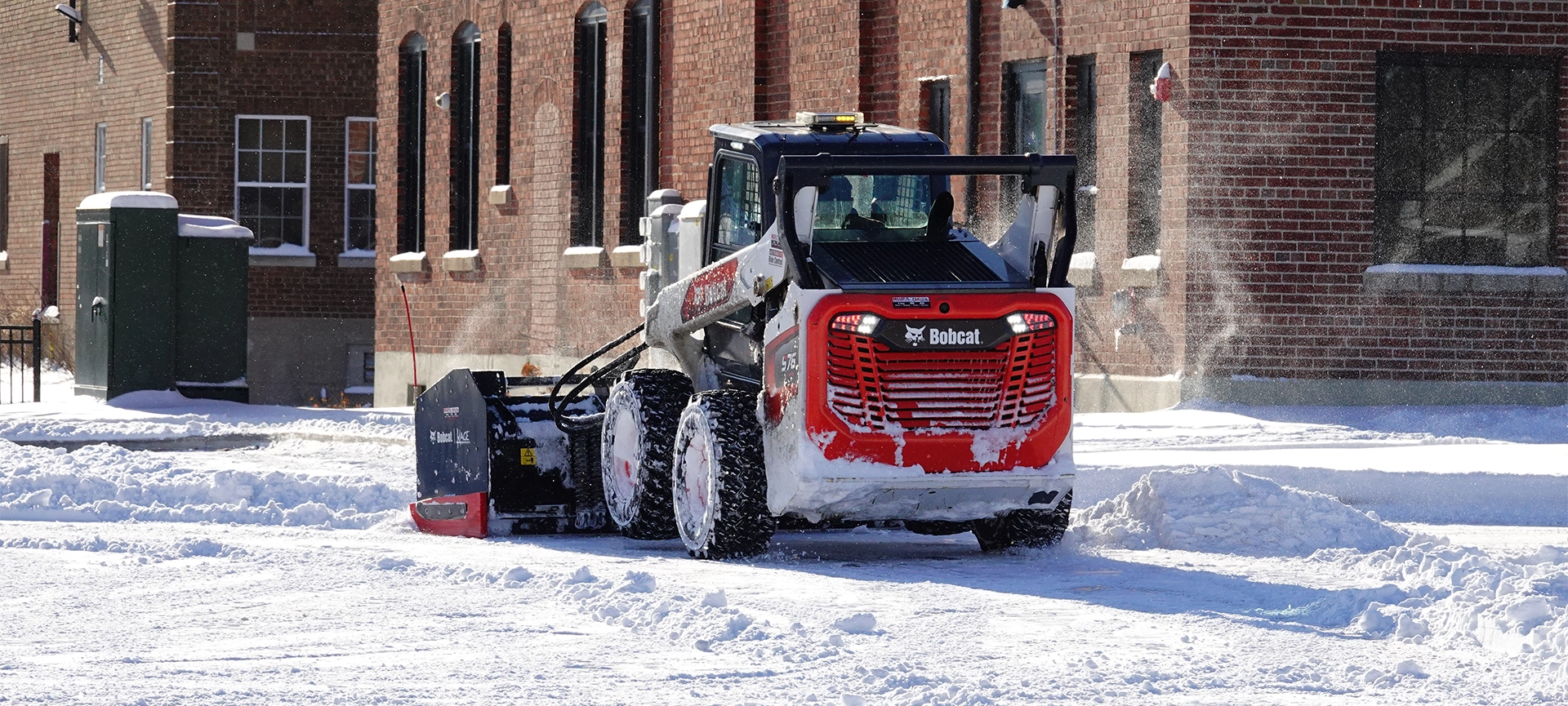 Bobcat Skid-Steer Loader being used to plow snow