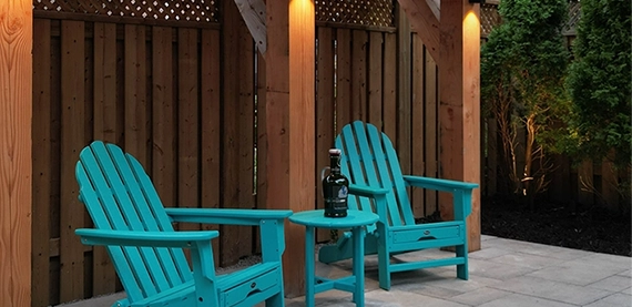 seating chairs near wooden fence in outdoor space