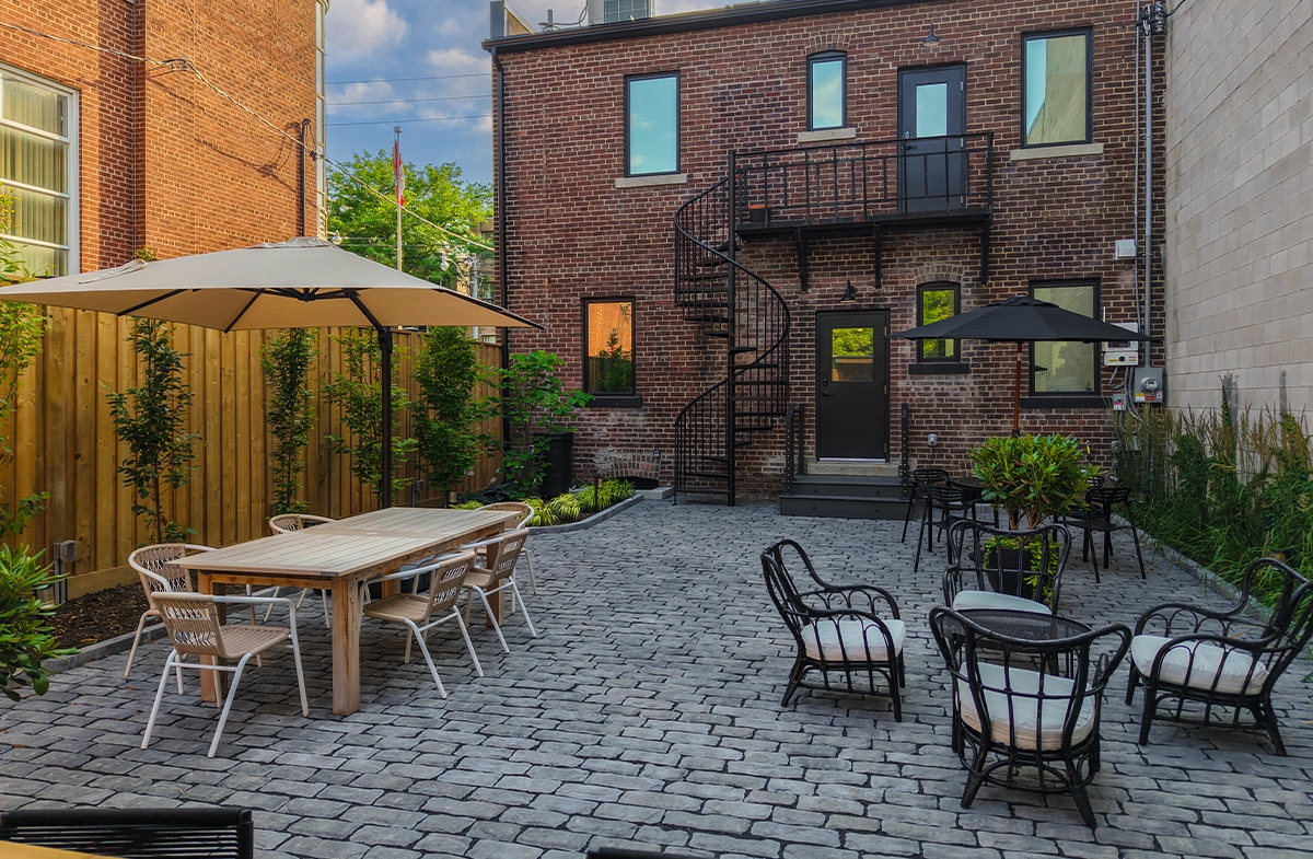 open bar with sitting setup, fence, landscaping, paver floor, brick walls building open bar with sitting setup, fence, landscaping, paver floor, brick walls building