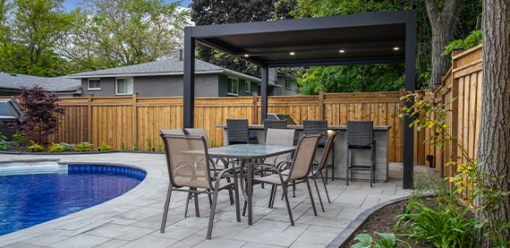 open kitchen with sitting space near pool in backyard