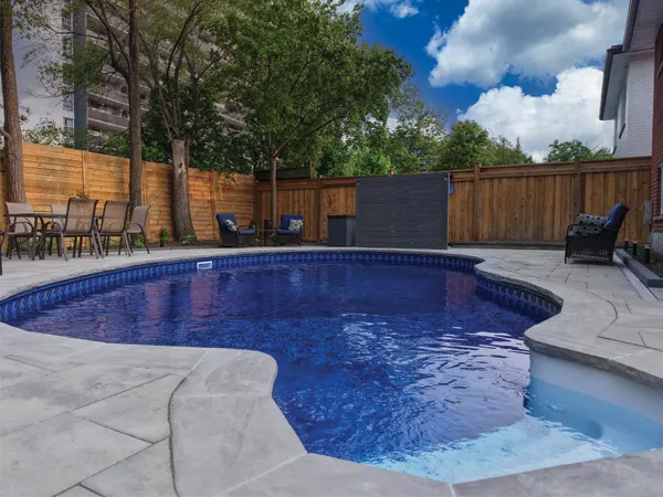 poolscape pool builders installing a pool in a backyard