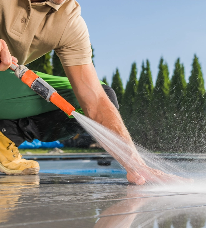 professional man washing timbertech deck