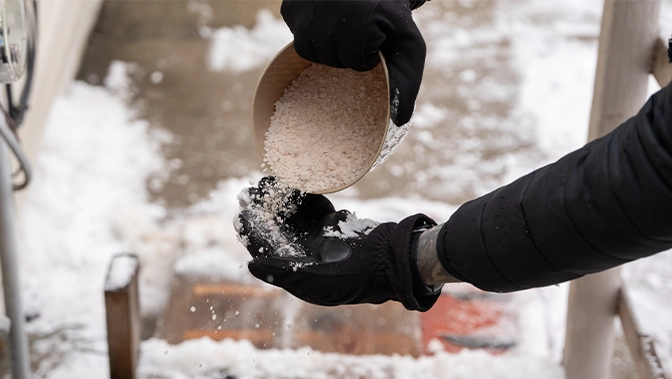 rock salt ice melt is being spread on your walkway to melt the ice and snow