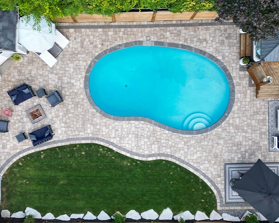 top view of home backyard, interlocking floor, pool, fence, landscaping