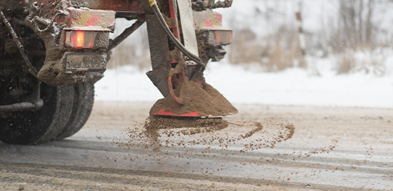 truck rock salting on road for de-icing
