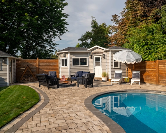Pool interlock restoration image three interlocking surface around pool and backyard space, custom carpentry storage room, sitting setup, fence and landscaping