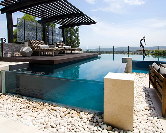 acrylic and glass walled pool with wood deck and sitting setup