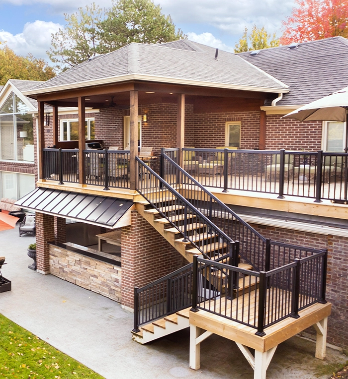 cabana and kitchen in home backyard, deck with steps and railing, interlock floor