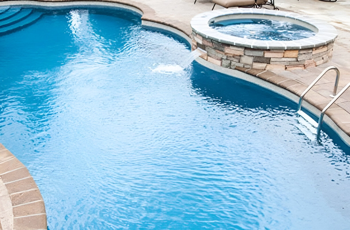 concrete large pool with small pool waterfall
