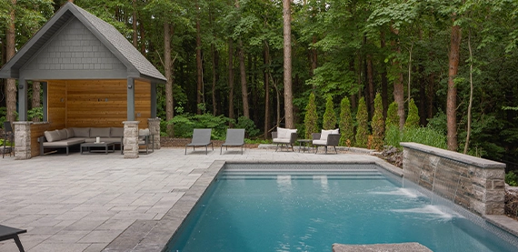 concrete pool water feature, in open backyard, custom carpentry for sitting space