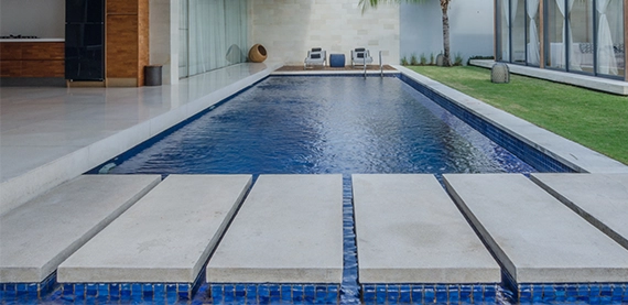 close up view of walkway steps above concrete pool