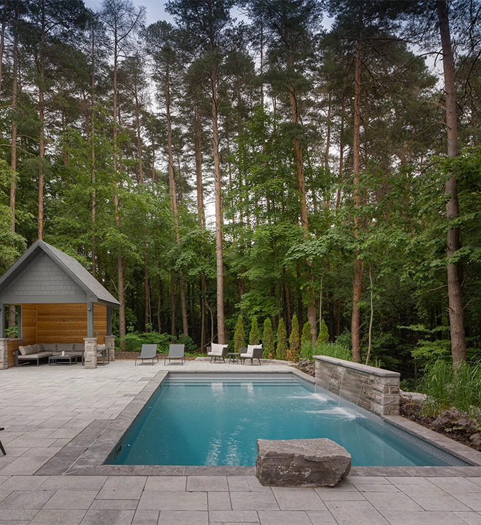 concrete pool water feature, in open backyard, custom carpentry for sitting space