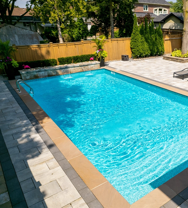 energy efficiency of vinyl pool vinyl pool with interlocking floor, landscaping and fence in backyard
