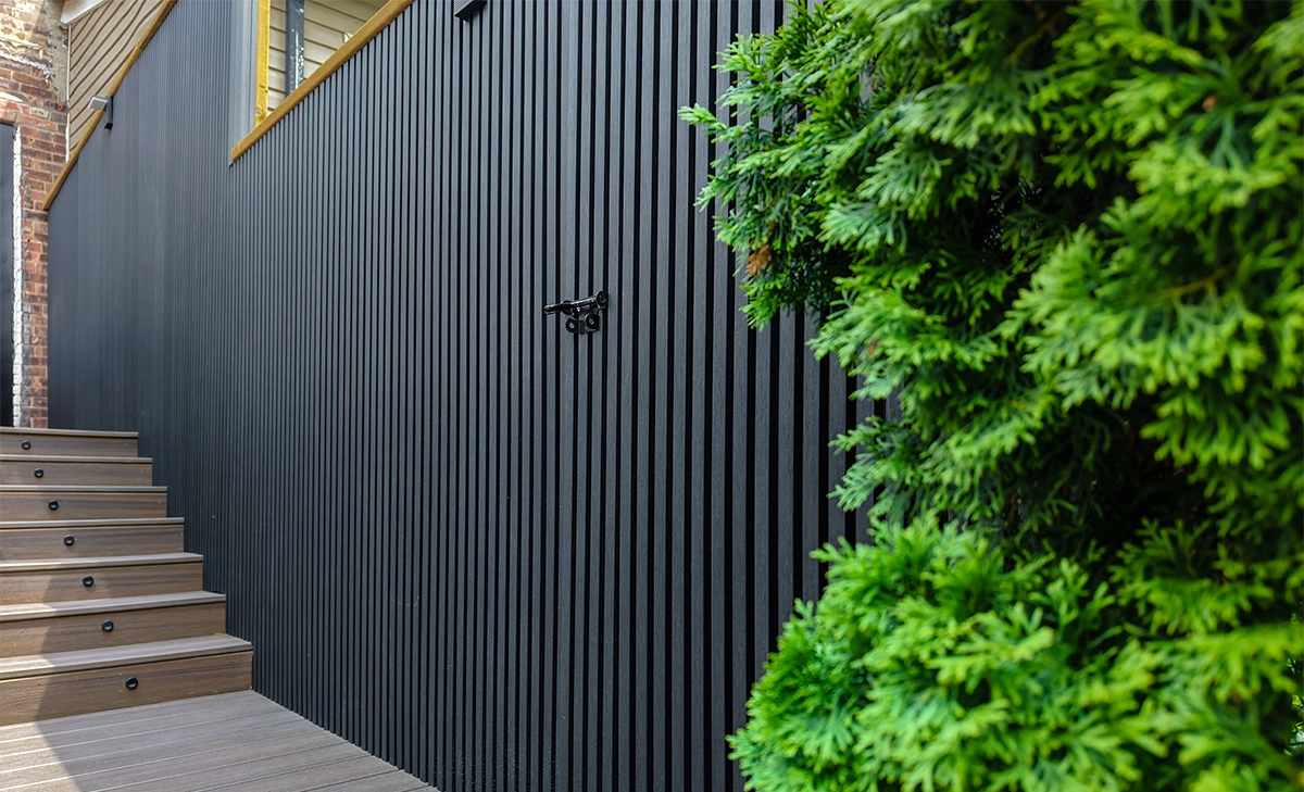 gate in modern fence, lighting feature in step and deck