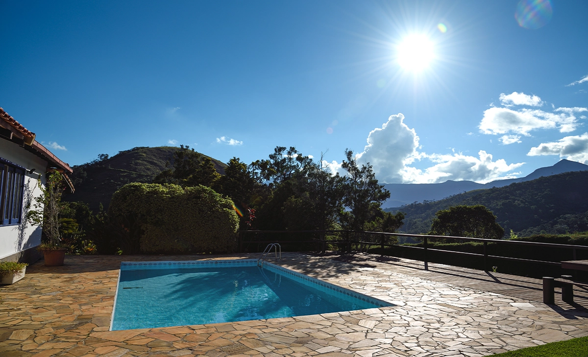 flagstone pool deck surface, home open back yard, mountains view