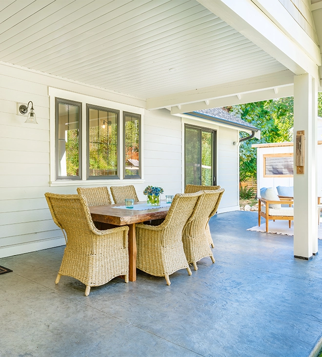 sitting setup under front porch, white walls and sliding door and windows