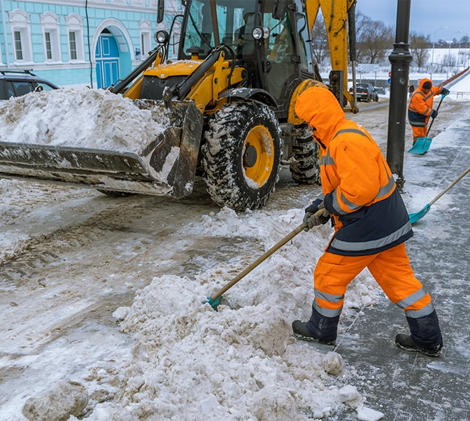 snow removal team clearing snow from road