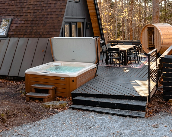 home front deck with sitting setup, outdoor sauna and hot tube