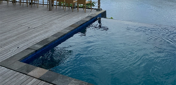 infinity pool img four infinity swimming pool with deck and waterfall feature