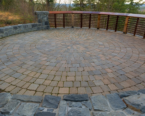 interlock patio image seven round shape interlock patio and small surrounding stone wall