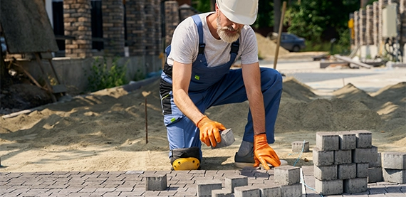 professional man installing interlock blocks