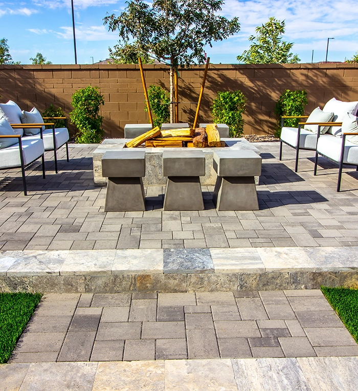 interlocking patio in yard with firepit and sitting setup