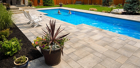 landscaping around pool interlocking deck