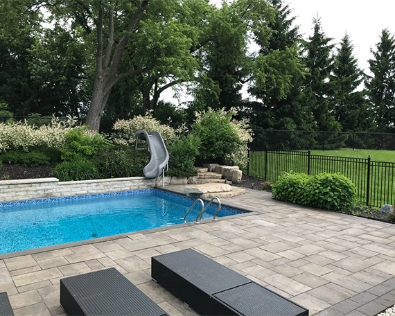 luxury pool with interlocking surface in yard