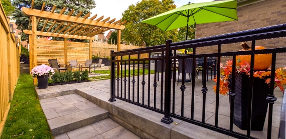 interlock steps toward backyard with side railing, sitting setup under cabana