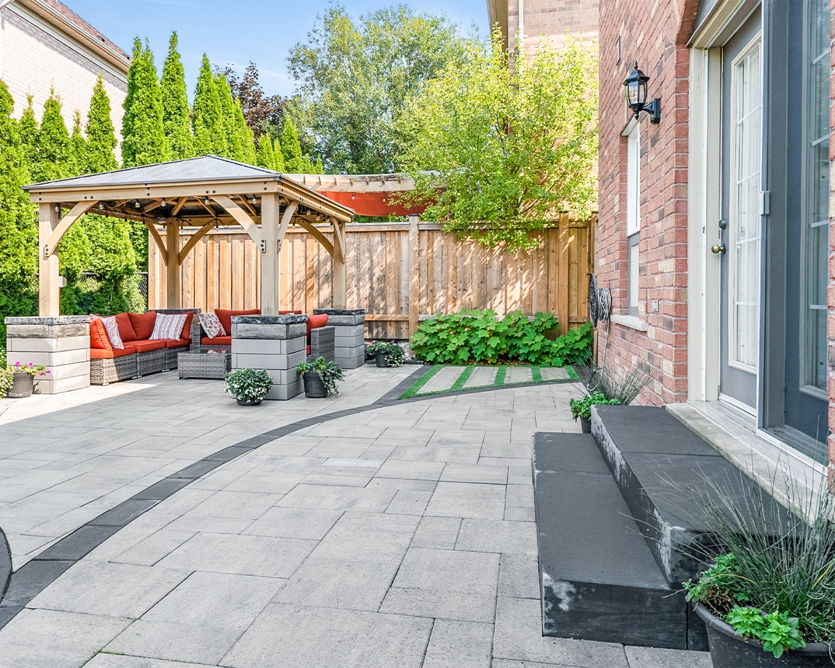 home backyard interlocking surface, sitting area under cabana with landscape