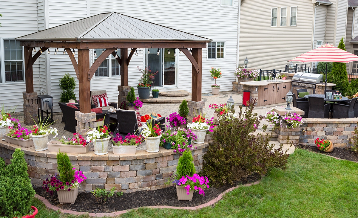 mixed colours retaining wall blocks home backyard view, paver patio, mixed colours retaining wall blocks, cabana and open kitchen with dinning area
