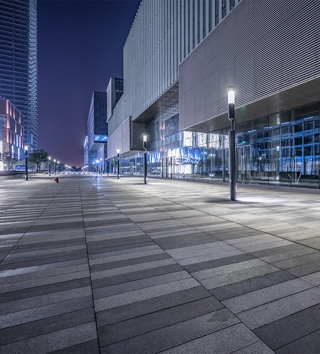 modern asphalt paving commercial road near commercial buildings, night view