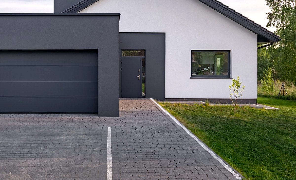 modern home with side garage and permeable pavers driveway