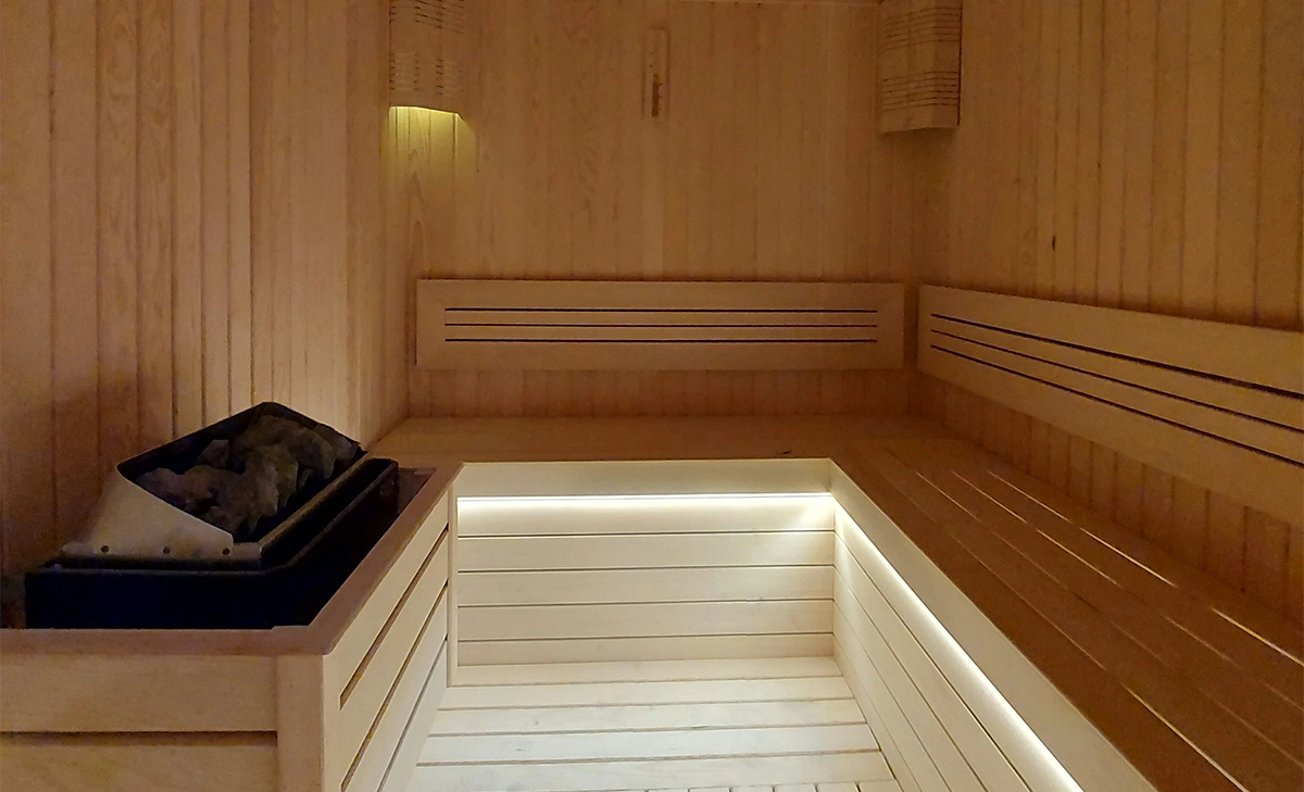 outdoor sauna with lighting feature and heat source