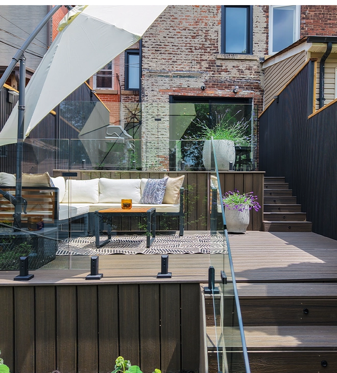 multi level deck with glass railing and steps. outdoor seating