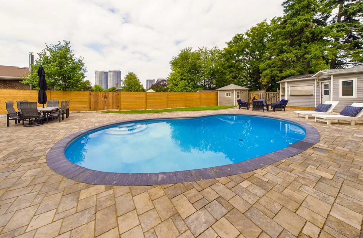 non-slippery area around the pool full backyard view, interlocking surface around swimming pool, custom carpentry, wooden fence and sitting setup