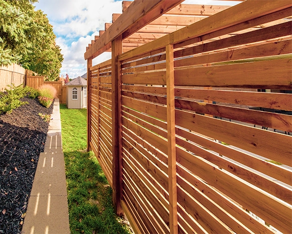 back view of outdoor privacy screen, in backyard near retaining wall