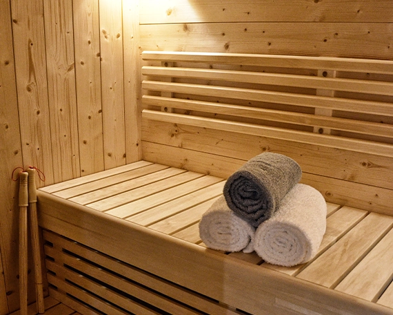 outdoor sauna, towels on bench, heat and light features